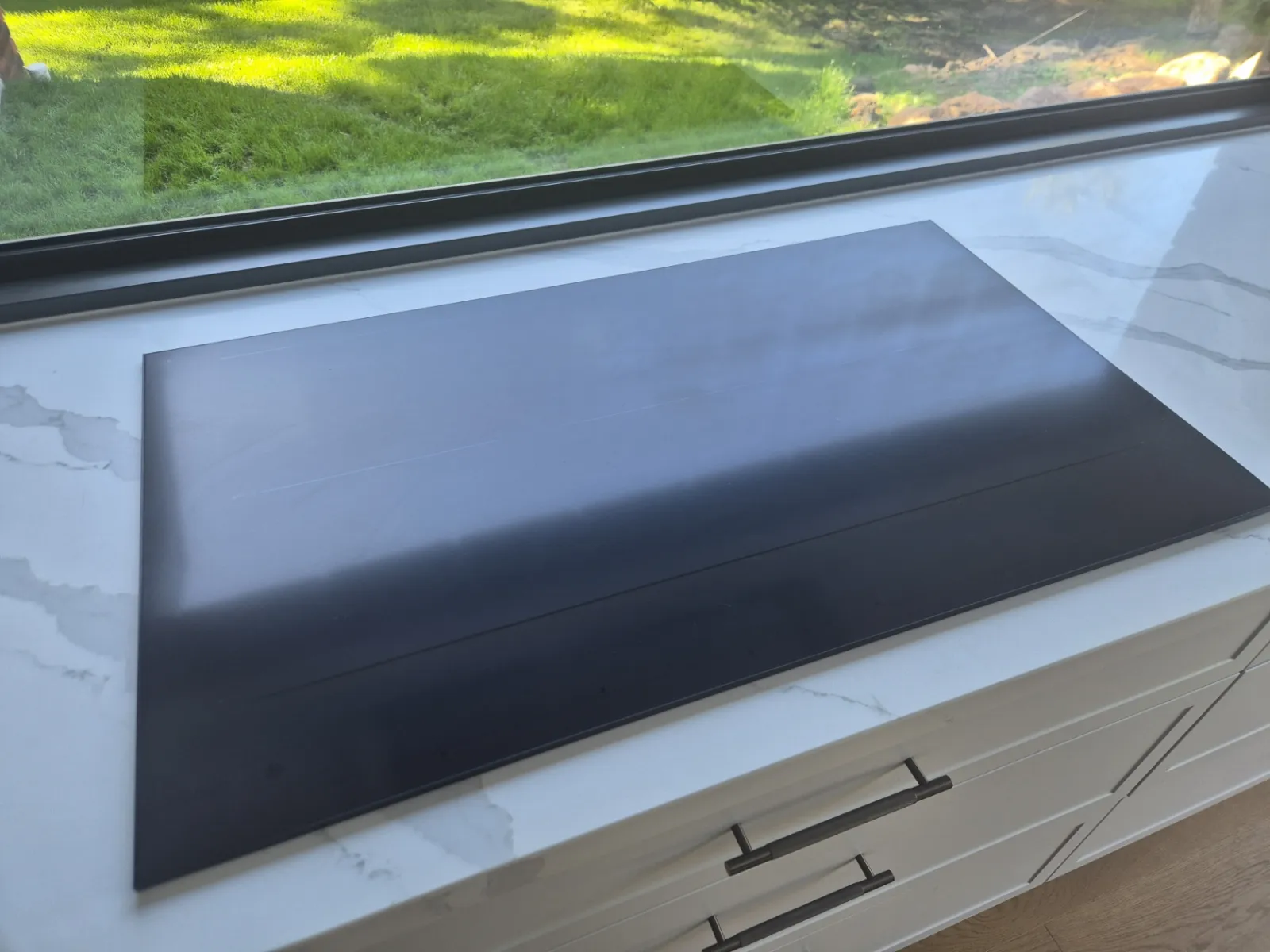 Newly installed induction cooktop on a stone benchtop