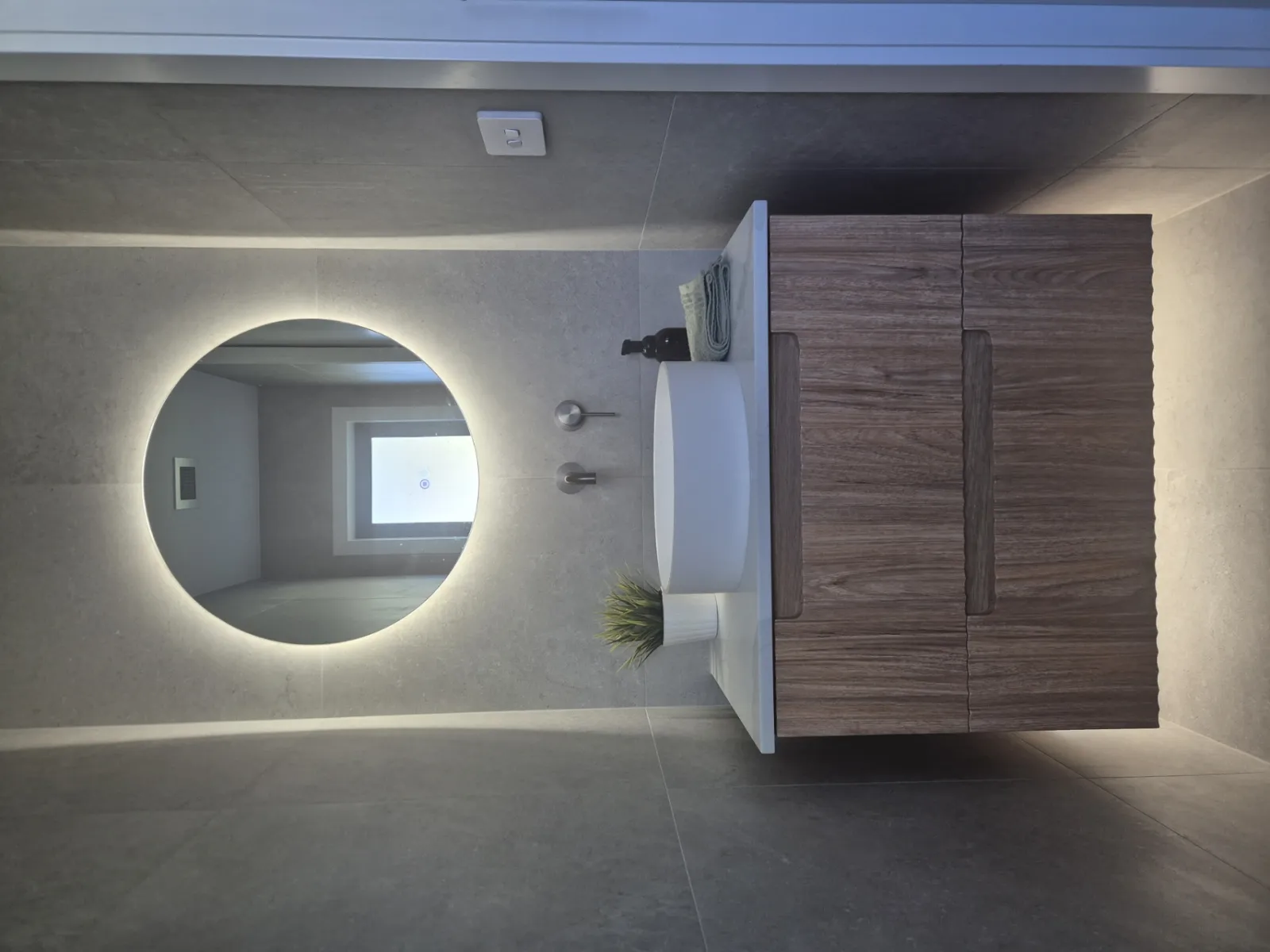 Powder room with subtle feature lighting around vanity